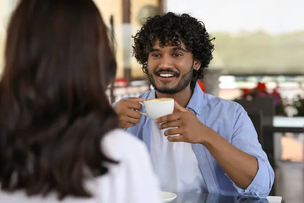 International dating. Lovely couple enjoying tasty coffee in cafe