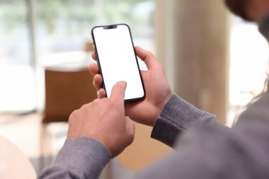 Kafede akıllı telefonunu kullanan adam, yakın plan.