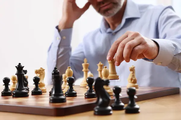 Man playing chess during tournament at table, closeup
