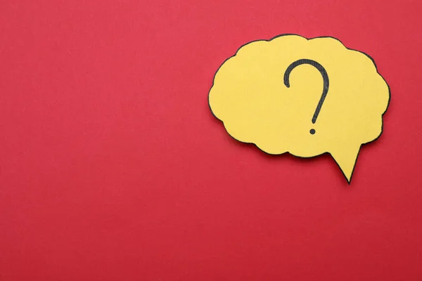Paper speech bubble with question mark on red background, top view. Space for text