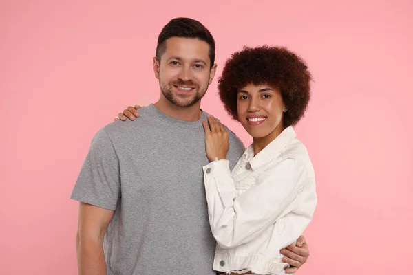 International dating. Portrait of lovely couple on pink background