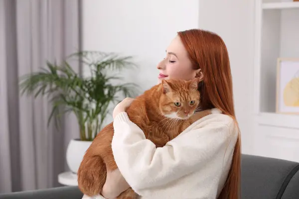 Woman with her cute cat at home