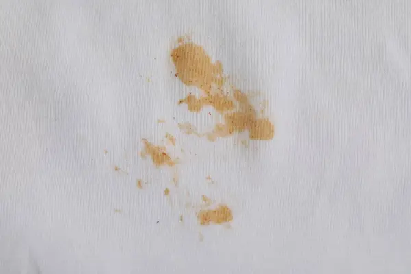 Closeup view of white shirt with stain
