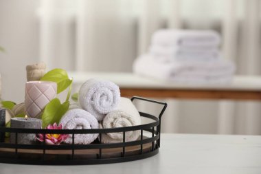 Farklı spa ürünleri içeren kompozisyon ve beyaz masa üzerinde mum yakma, metin için boşluk