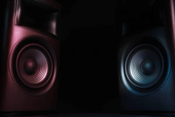 Modern sound speakers in neon light on black background. Space for text