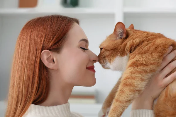 Woman with her cute cat at home