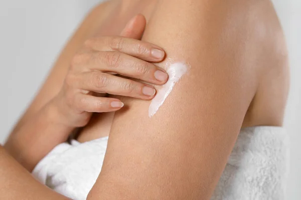 Woman Applying Body Cream Arm Grey Background Closeup Stock Image