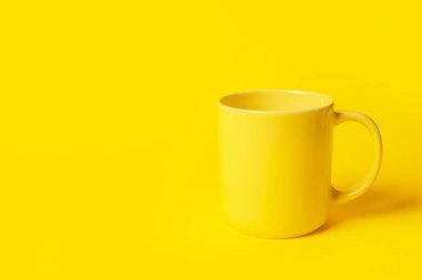 Sarı arkaplanda bir seramik bardak, metin için boşluk