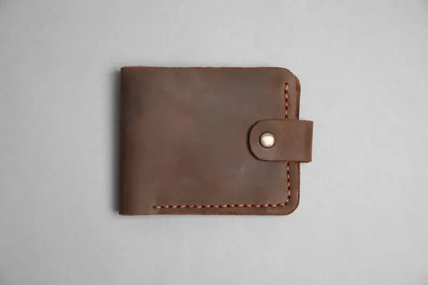 Stock image Stylish brown leather wallet on light grey background, top view