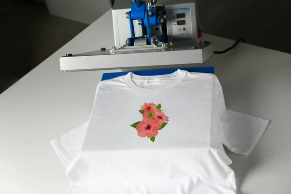Custom t-shirt. Using heat press to print image of beautiful hibiscus flowers