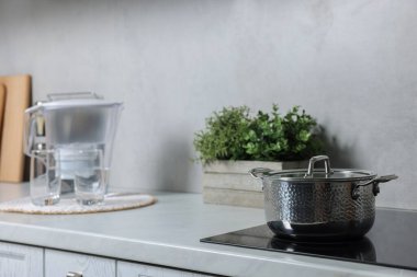 Mutfaktaki beyaz tezgahın üzerine yapay bitki ve ot yerleştirdim.