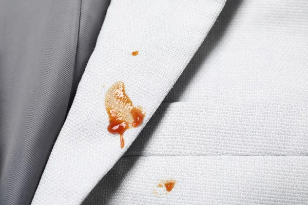 Dirty jacket with stains of sauce, top view