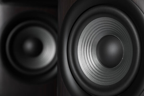 Two modern sound speakers as background, closeup