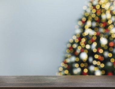 Güzel dekore edilmiş Noel ağacının yanındaki ahşap masa. Tasarım için boşluk