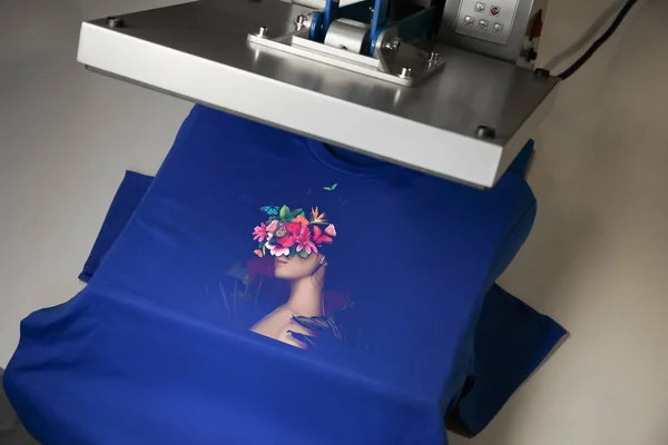 Custom t-shirt. Using heat press to print creative image of woman with beautiful flowers