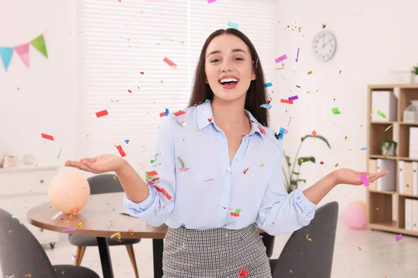 Young woman having fun during office party indoors