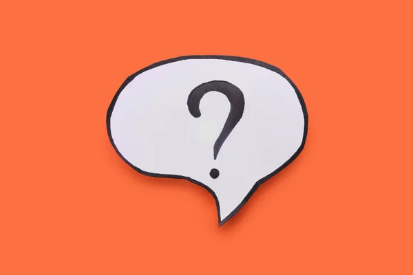 Paper speech bubble with question mark on orange background, top view