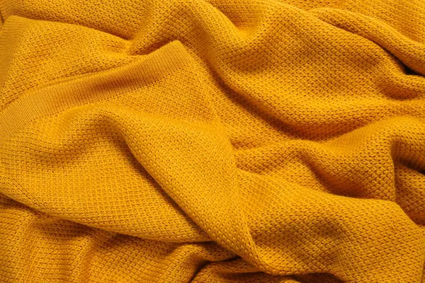 Texture of yellow knitted blanket as background