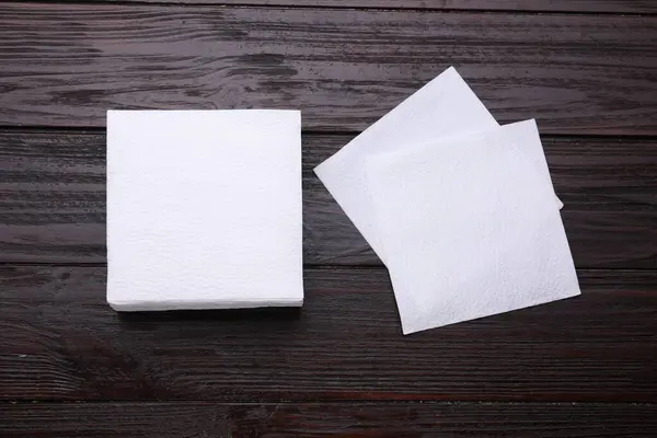 Clean paper tissues on wooden table, flat lay