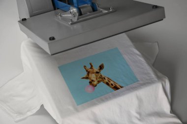 Custom t-shirt. Using heat press to print image of giraffe blowing bubble gum clipart