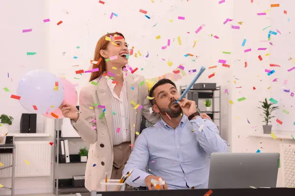 Coworkers having fun during office party indoors