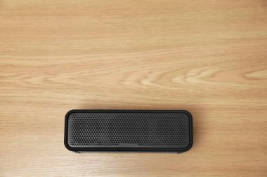 Bir portatif bluetooth hoparlörü ahşap masada, üst görünümü metin için alan. Ses ekipmanları