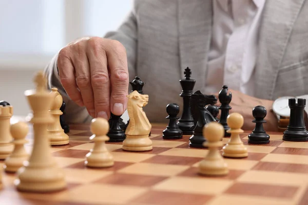 Man playing chess during tournament at chessboard, closeup