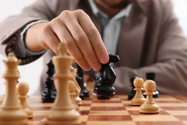 Man playing chess during tournament at chessboard, closeup