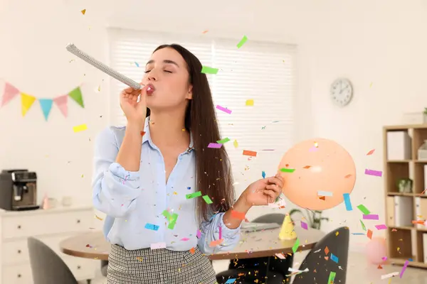 Young woman having fun during office party indoors