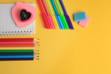 Flat lay composition with different school stationery on yellow background, space for text. Back to school