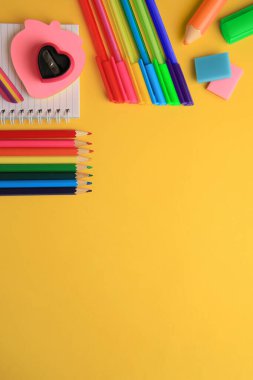 Flat lay composition with different school stationery on yellow background, space for text. Back to school