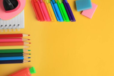Flat lay composition with different school stationery on yellow background, space for text. Back to school