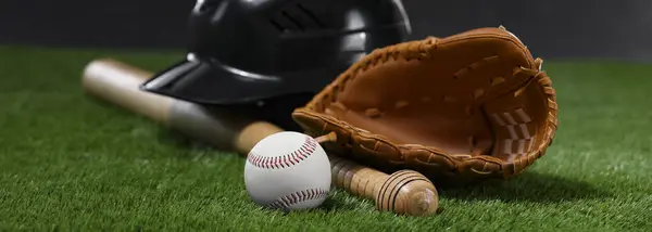Leather baseball glove, batting helmet, bat and ball on green grass, banner design