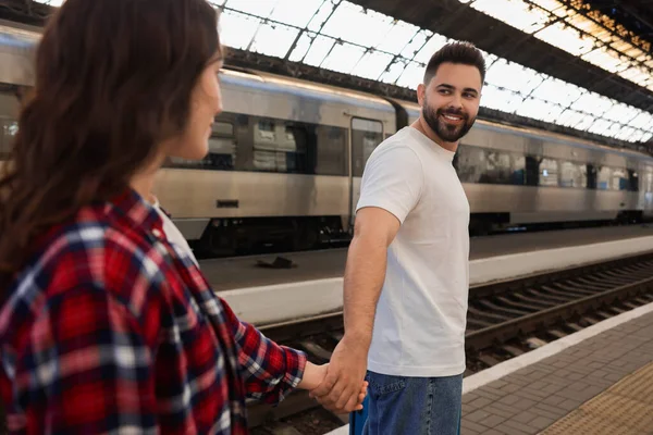 Long-distance relationship. Couple walking on platform of railway station