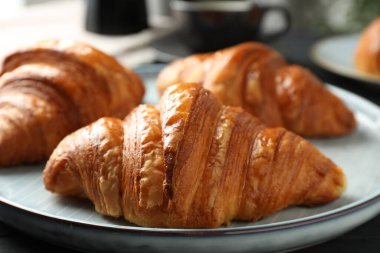 Karanlık masadaki enfes taze kruvasanlar, yakın plan.