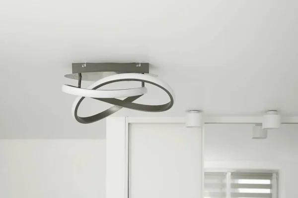 Stylish lamp on white ceiling. Space for text