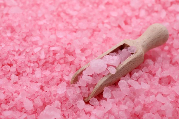 Scoop with pink sea salt, closeup view. Space for text