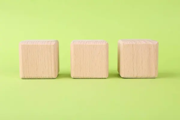 International Organization for Standardization. Wooden cubes with abbreviation ISO on light green background