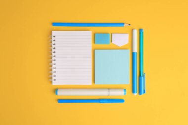 Flat lay composition with different school stationery on yellow background, space for text. Back to school