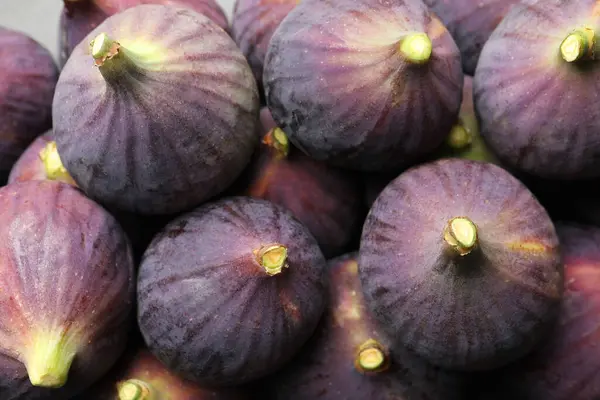 Fresh ripe figs as background, closeup view