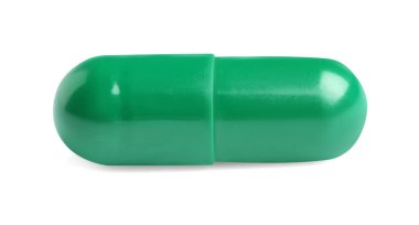 Beyaz arka planda bir yeşil hap. Tıbbi tedavi