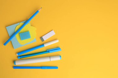 Flat lay composition with different school stationery on yellow background, space for text. Back to school