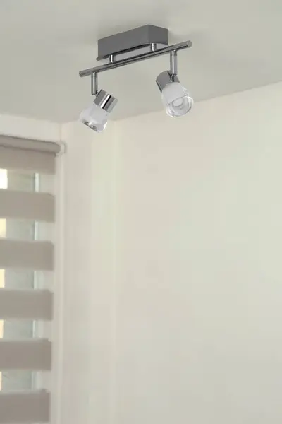 Stylish light fixture on ceiling indoors, low angle view