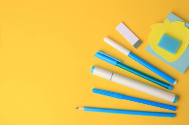 Flat lay composition with different school stationery on yellow background, space for text. Back to school