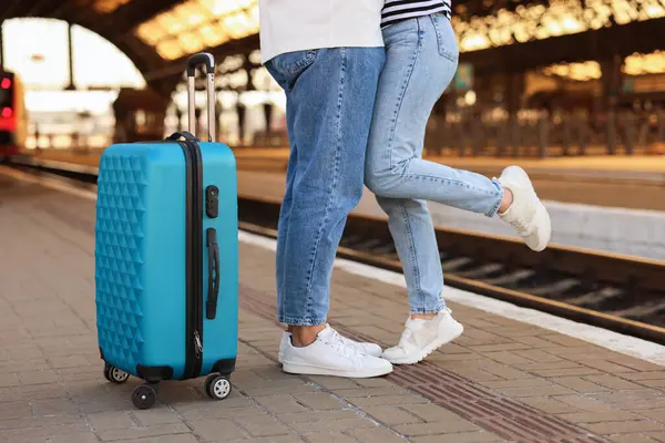 Long-distance relationship. Couple on platform of railway station, closeup