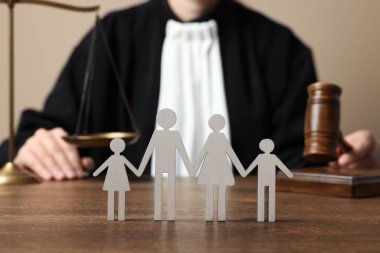 Aile hukuku. Tahta masada oturan tokmak ve adalet terazisiyle yargıla, ebeveynlerin ve çocukların figürlerine odaklan.