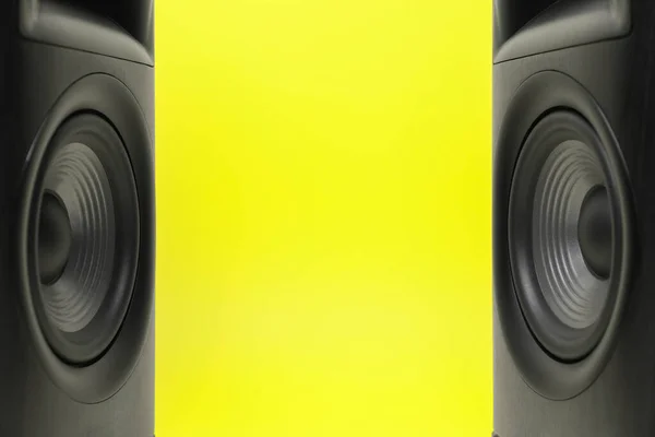 Wooden sound speakers on yellow background, closeup. Space for text