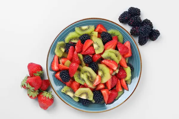 Plate Yummy Fruit Salad Ingredients Light Blue Background Flat Lay — Stock Photo, Image