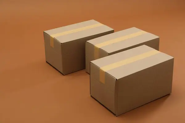 Group of closed cardboard boxes on brown background