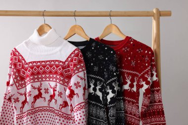 Farklı Noel süveterleri, arka planda asılı